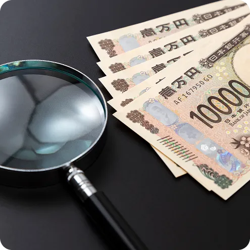 査定と買取を表すルーペと紙幣